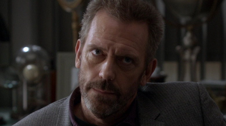 House tilts his head and looks up