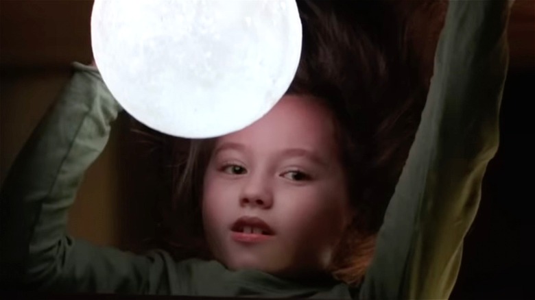 Girl under a glowing ball