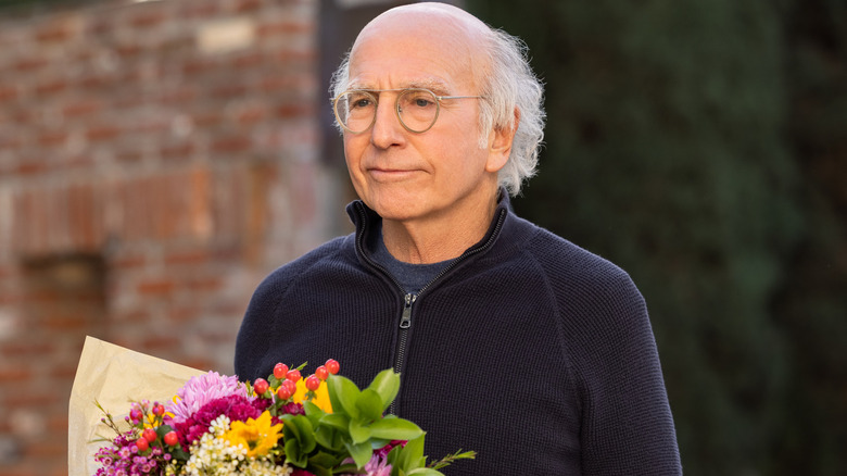 Larry David holding flowers