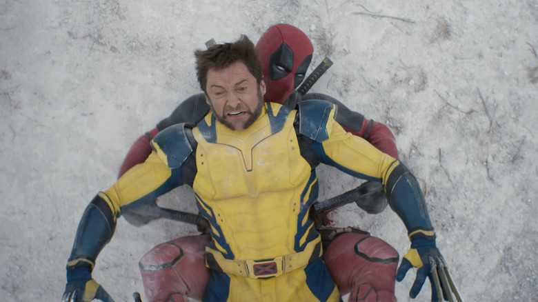 Wolverine lying down on Deadpool