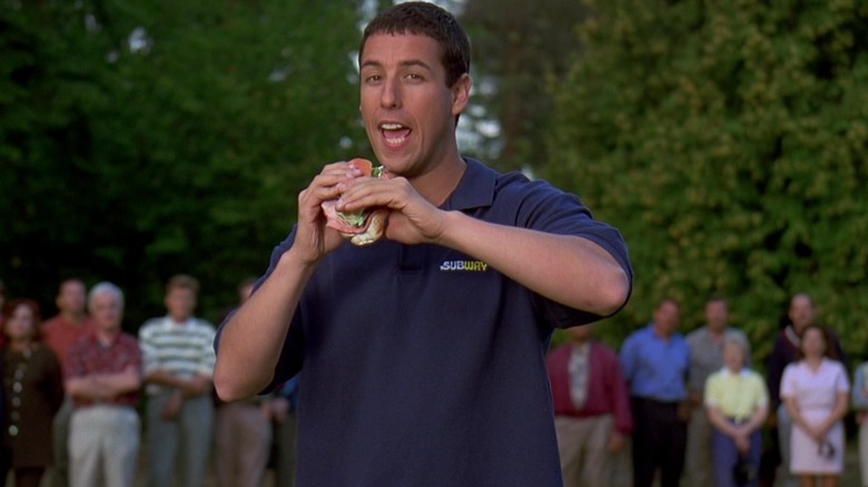 Happy Gilmore eating a sandwich