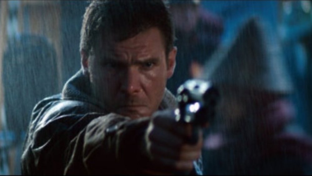 Harrison Ford as Rick Deckard firing a gun in Blade Runner