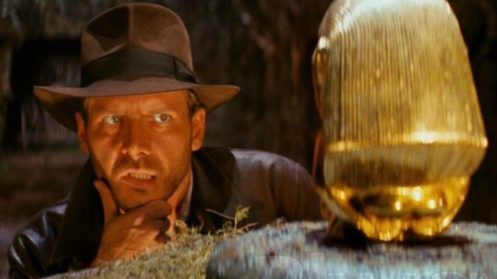 Indiana Jones eyes the golden idol in Indiana Jones and the Raiders of the Lost Ark