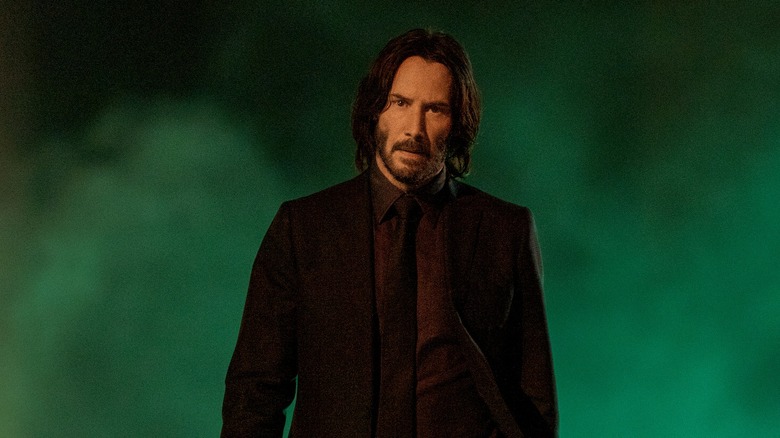 John Wick standing against a foggy background