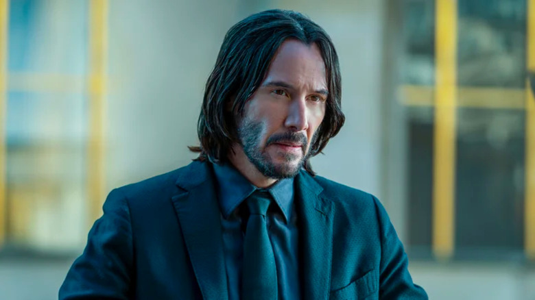 John Wick sitting at a table