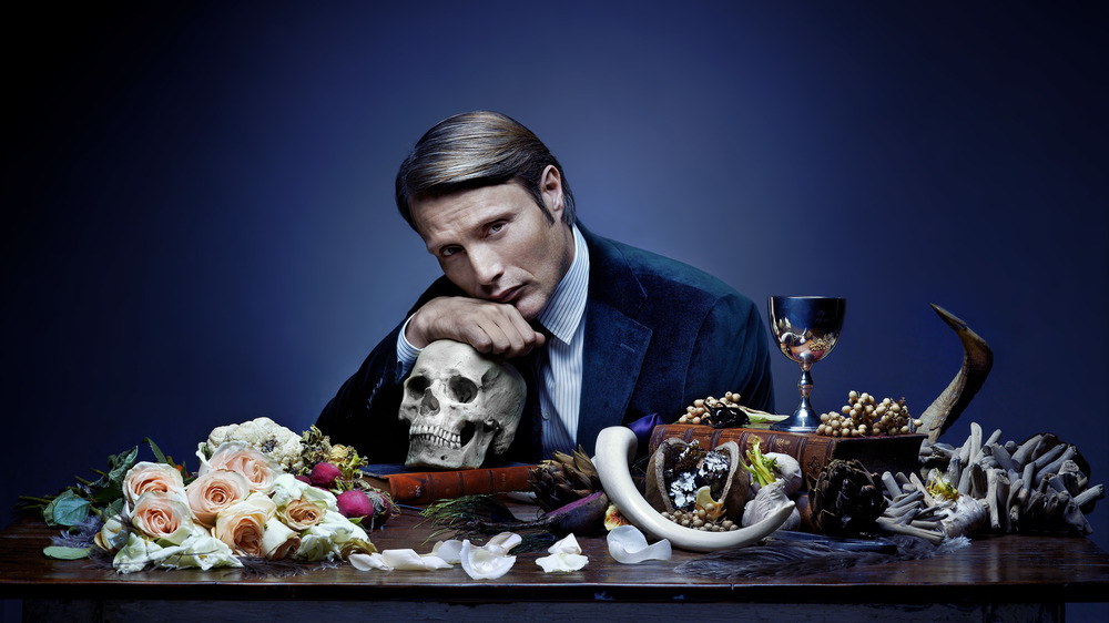 Hannibal at table with flowers and bones
