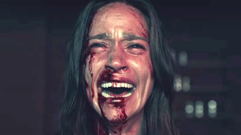 Woman crying with blood on her face