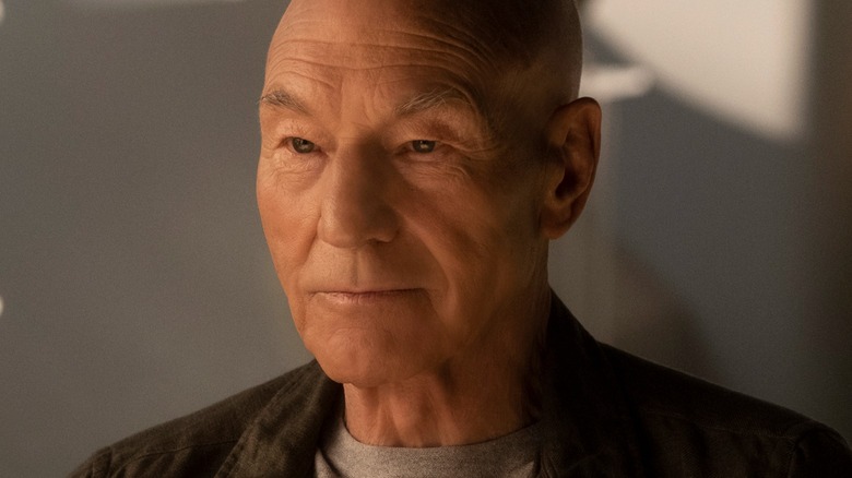 Picard sits in front of grey background