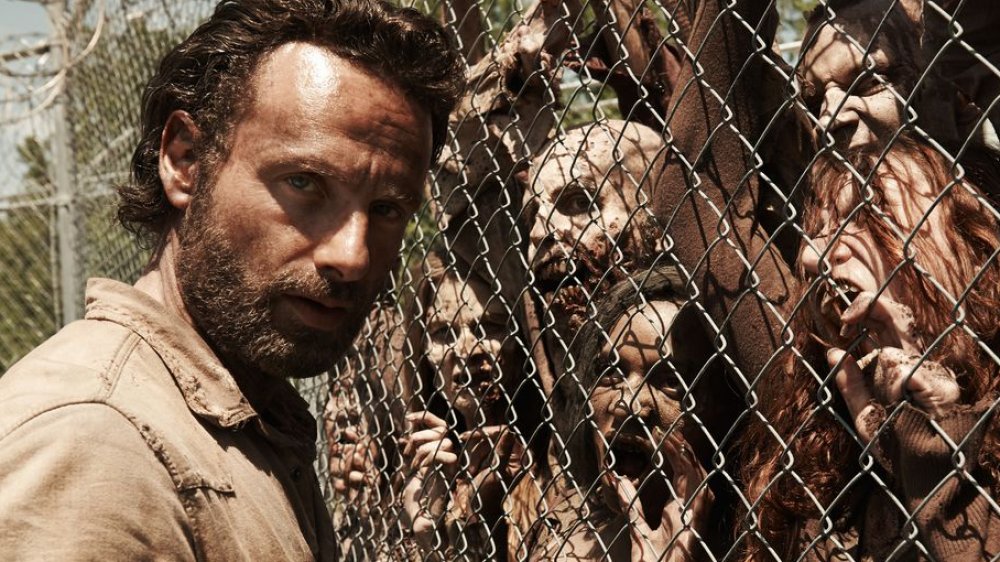 Andrew Lincoln as Rick Grimes on The Walking Dead beside walkers, not zombies