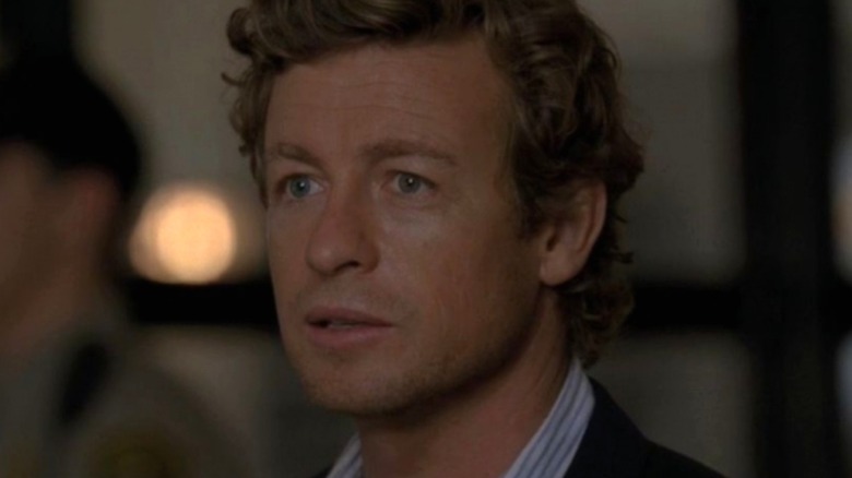 Jane looking to his right at Lisbon The Mentalist