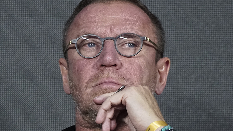 Renny Harlin glasses scratches his chin
