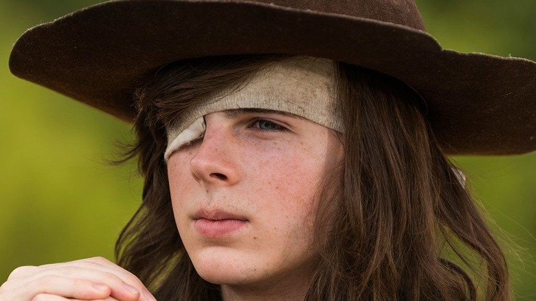 Carl wearing a hat and eye patch in The Walking Dead