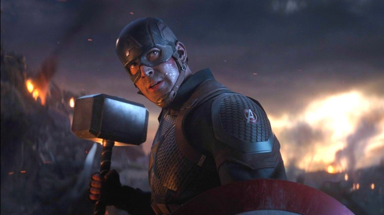 Captain America holding Thor's hammer