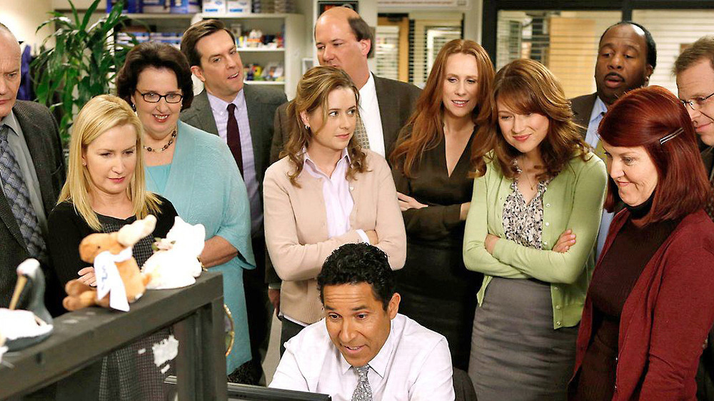 The cast gathers around in the final season of The Office