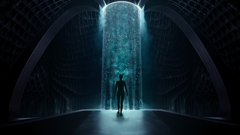 Person standing in a glowing chamber